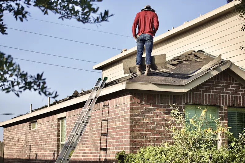 Professional roofer working on a residential roof in Olivehurst